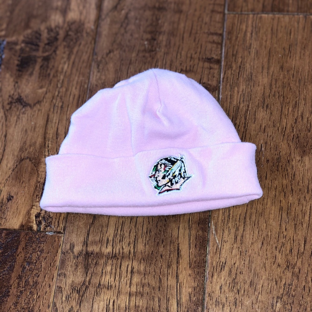 Newborn baby fighting Sioux hat